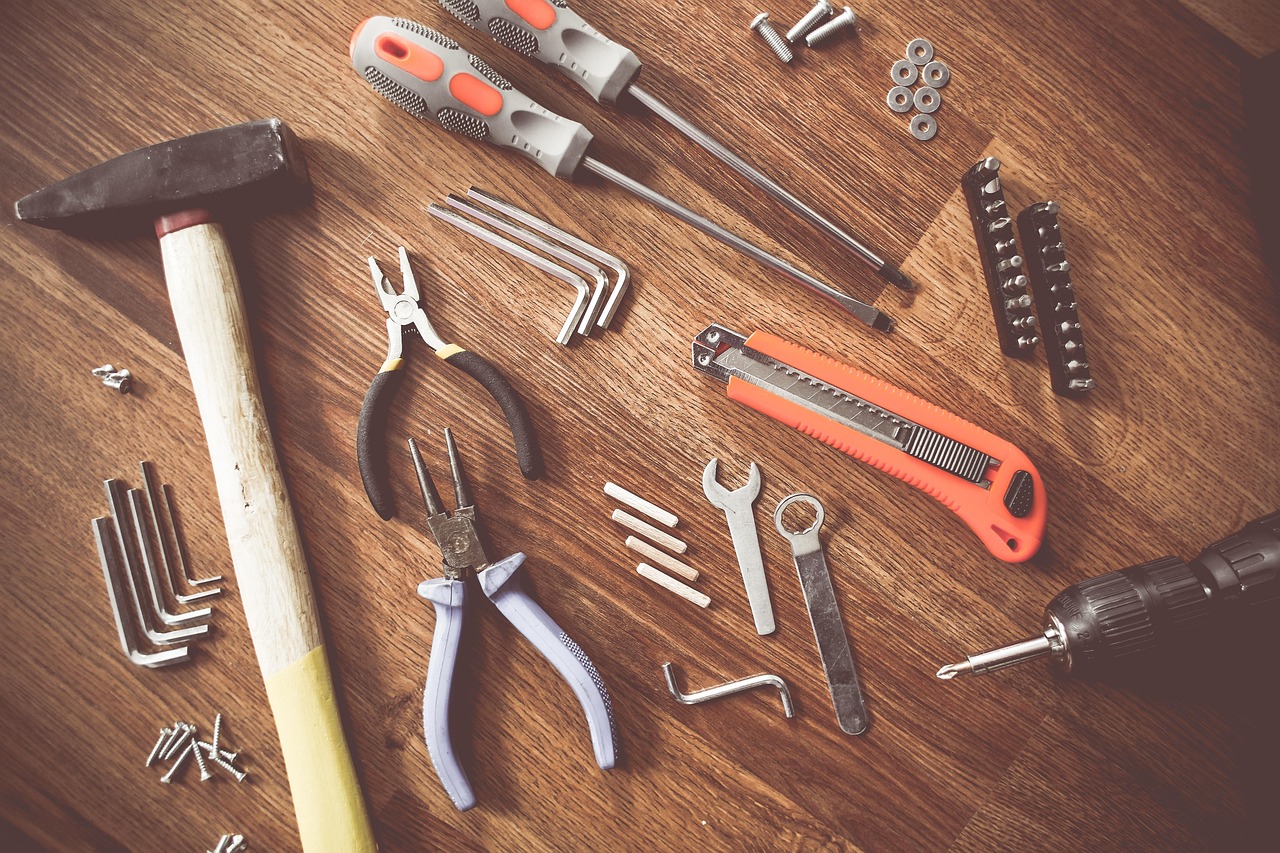 Hand tools laid out on a wooden workbench